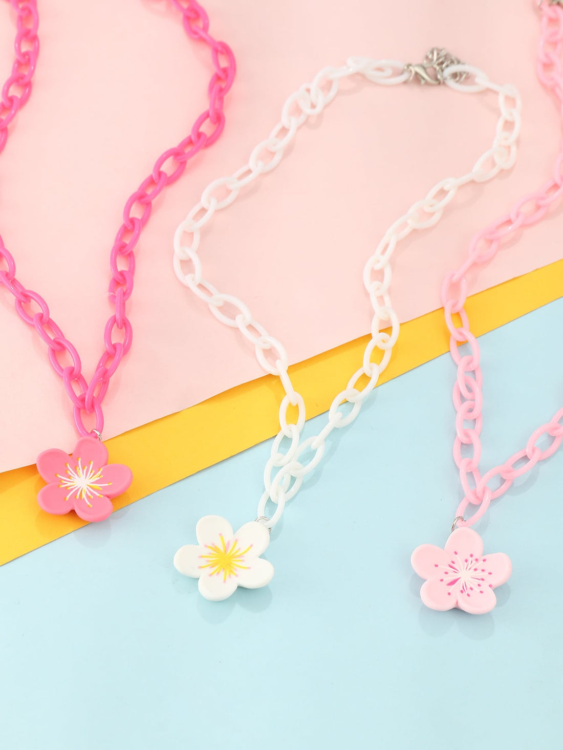 The Charming Blossoms 3-Piece Flower Charm Necklace Set for Girls is the perfect accessory for any young fashionista. Crafted with care, this set features delicate flower charms that add a touch of whimsy to any outfit. With three charming pieces, your little girl can mix and match for playful versatility.