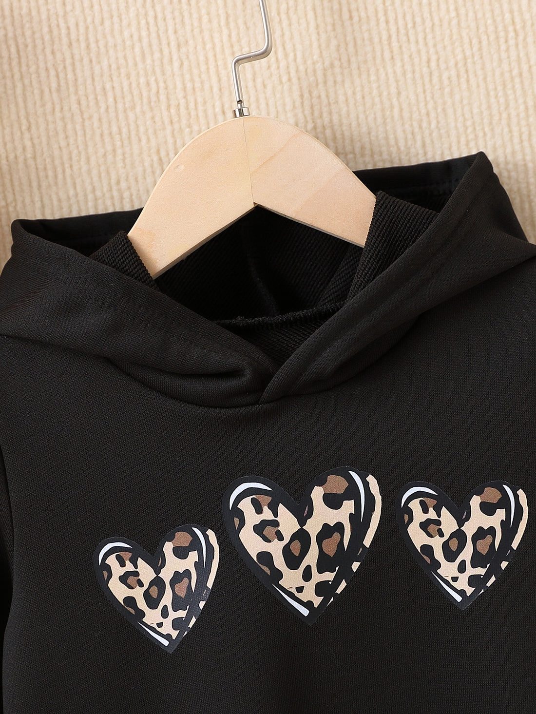 Stay warm and stylish with our Adorable Young Girls' Heart Print Hoodie. Made with soft, cozy fabric, this hoodie features a cute heart print design that will make your little one stand out. Perfect for any occasion, keep your child comfy and cute all day long.