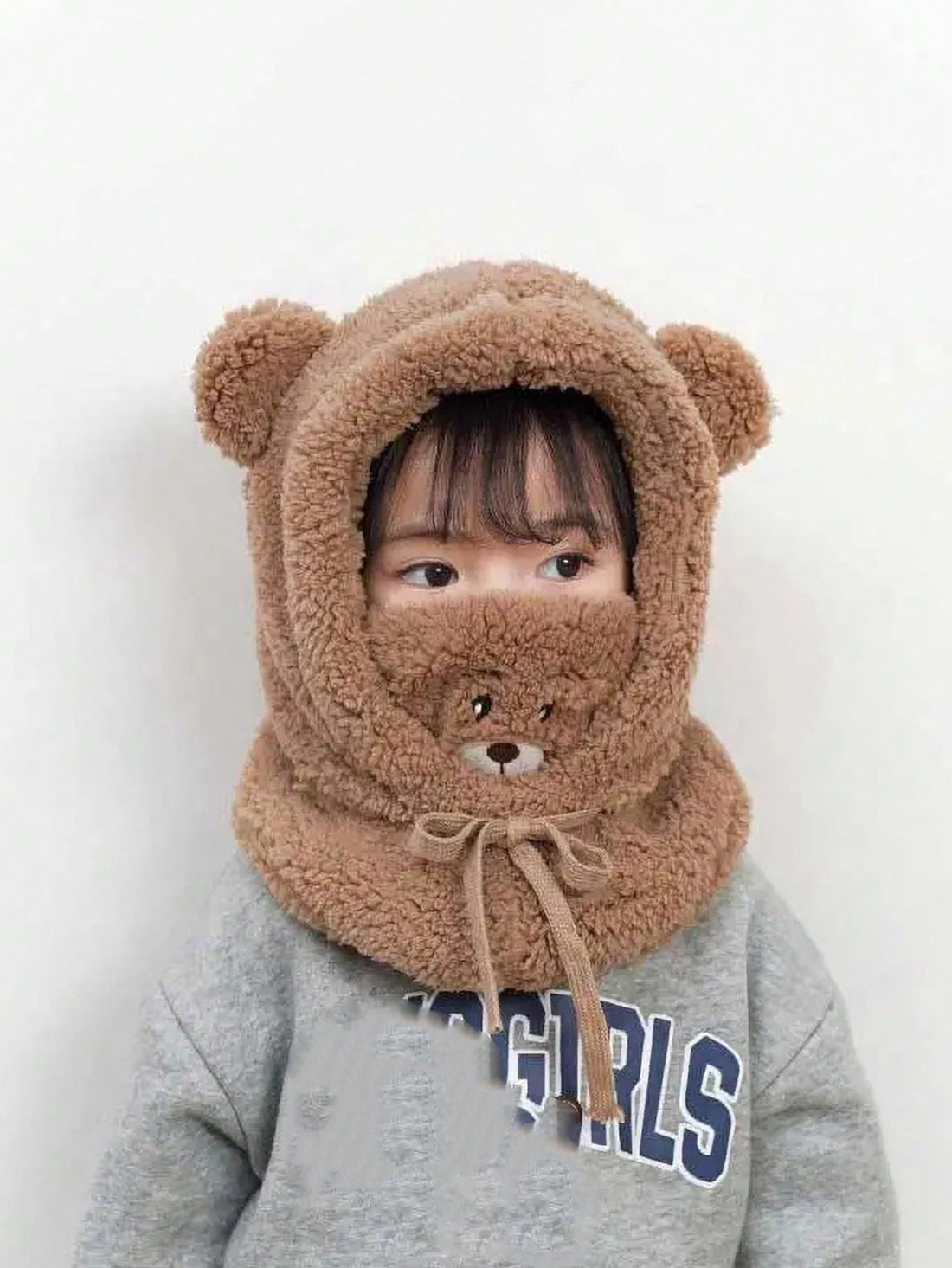 This cozy and cute Snuggle Up in Style bear hat not only protects your child from the winter chill, but also features a face cover and scarf for added warmth. Made for kids, this hat is both functional and fun, making outdoor playtime comfortable and stylish.