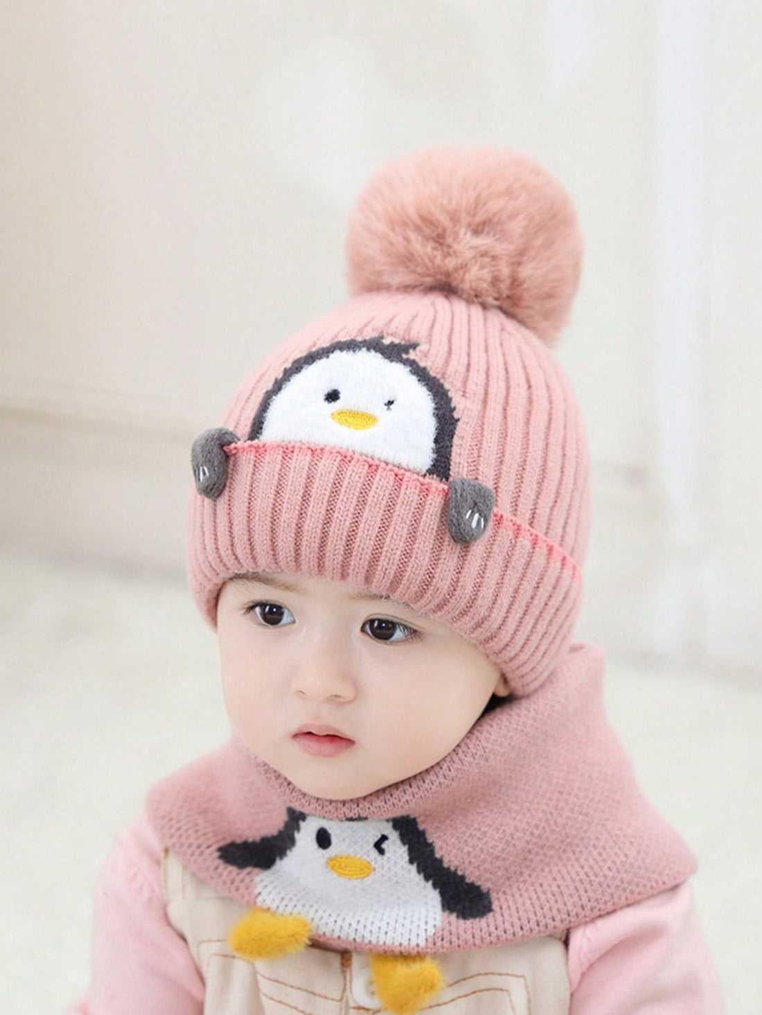 Stay warm and stylish with our Adorable Little Penguin Hat and Scarf Set! Made with soft, cozy material, this set is gentle on your baby's skin. Perfect for winter outings, our cute penguin design will keep your little one looking fashionable and feeling comfortable.