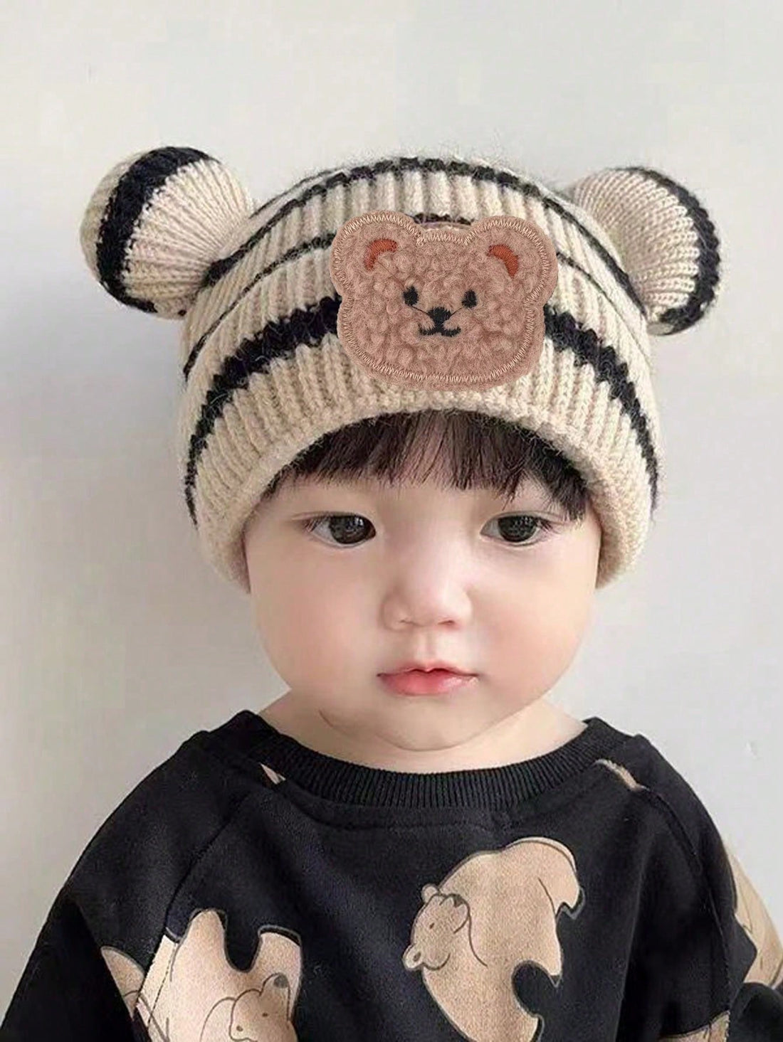 Keep your little one warm and stylish this winter with our Cozy and Cute children's beanie. Its knitted design features a charming striped bear pattern, providing both comfort and cuteness. Perfect for any winter outfit, this beanie is a must-have for your child's wardrobe.