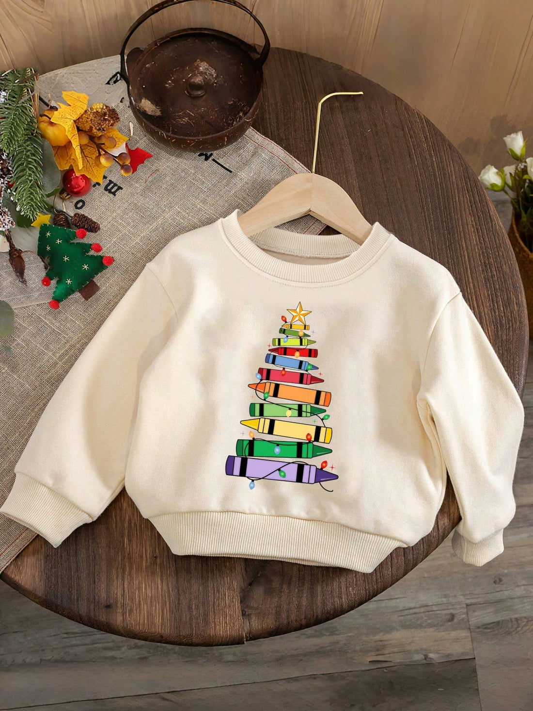 Stay festive and stylish this holiday season with our Festive Flair sweatshirt! Featuring a fun Christmas tree pencil print, this sweatshirt is perfect for young girls looking for a casual and comfortable outfit. Made with quality materials, it's a must-have addition to any holiday wardrobe.