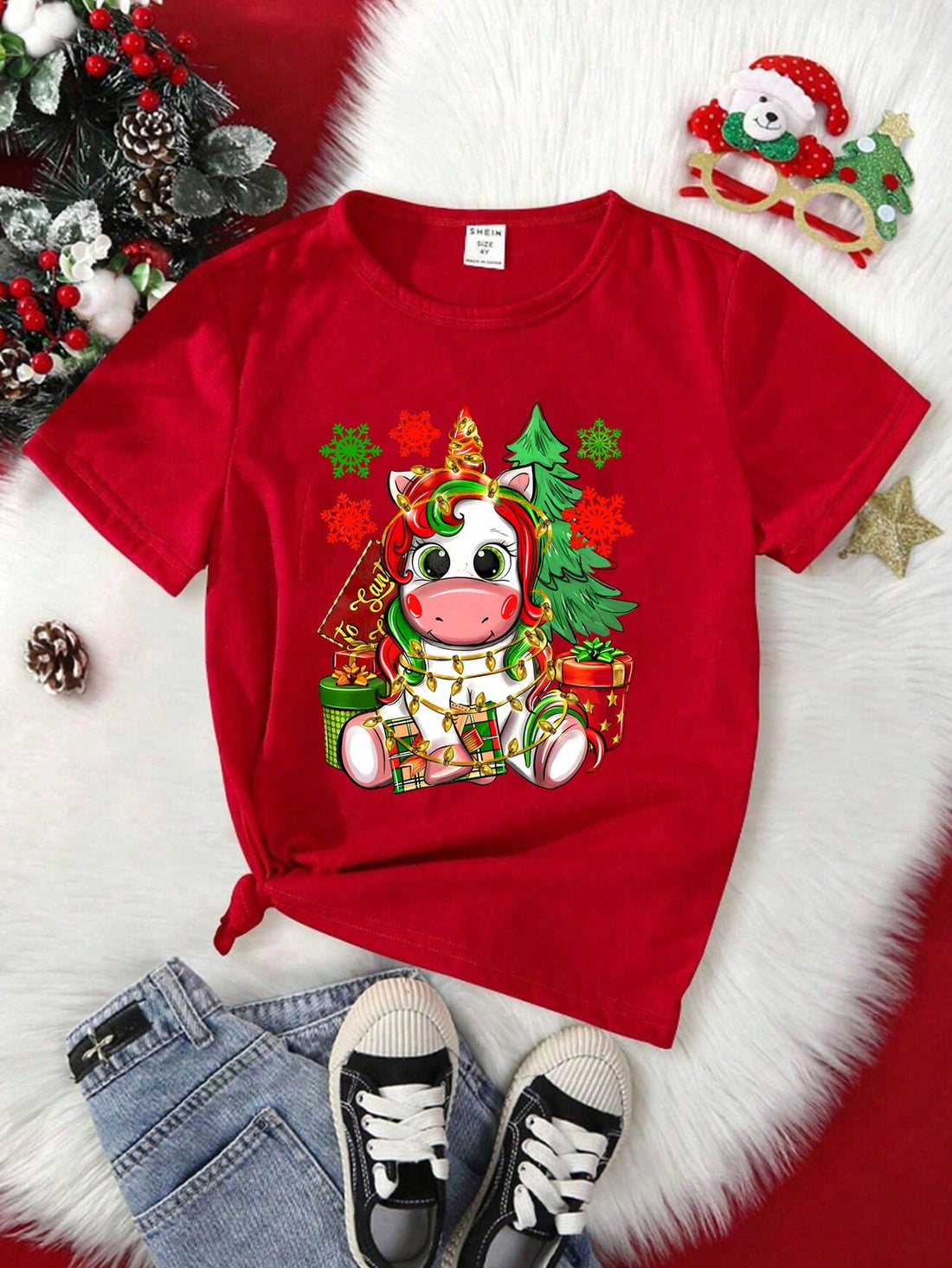 Effortlessly spread holiday cheer with our Christmas Cartoon Fun T-Shirt. Made with a comfortable crew neck and short sleeves, this tee showcases a playful design of a young girl enjoying the festive season. Crafted with high-quality materials for a breathable and soft fit. Perfect for adding some festive fun to your wardrobe.