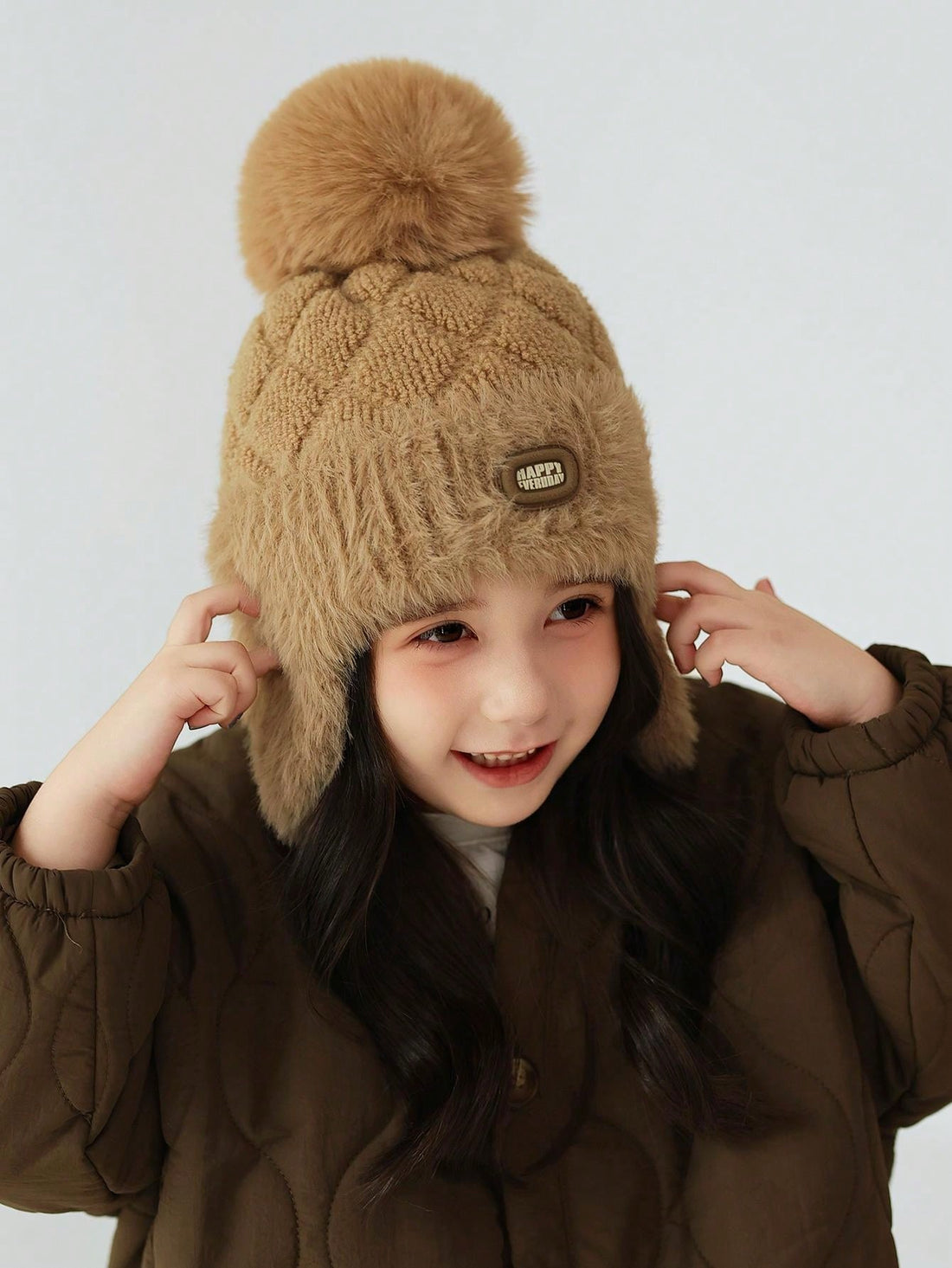 Stay cozy and stylish on all your outdoor adventures with our Girls' Fleece-Lined Knitted Winter Hat. The soft, fleece lining will keep your little one warm and comfortable, while the adorable pompom adds a fun touch. Perfect for skiing and other winter activities, this hat is designed for ages 4-10.